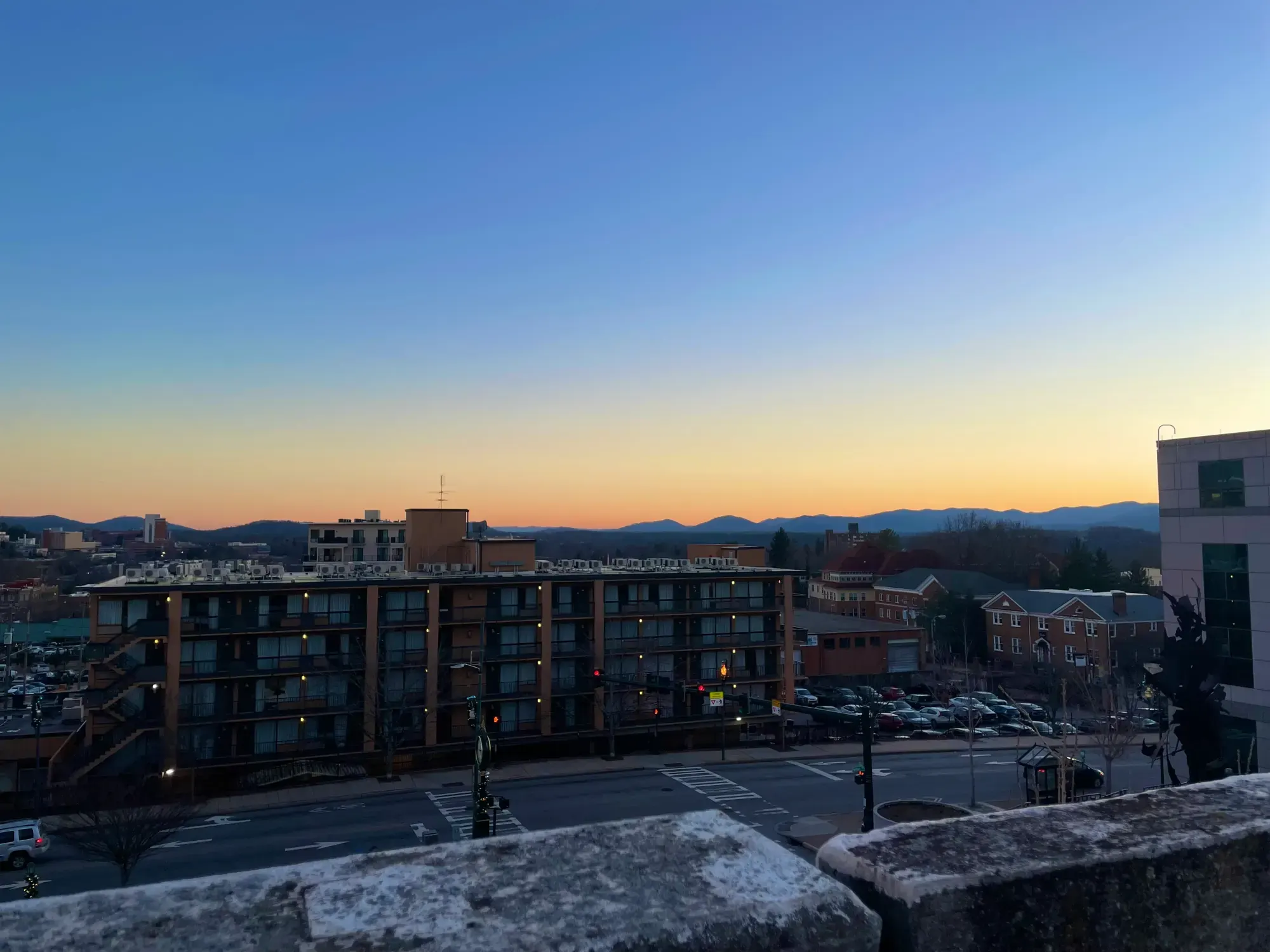 Asheville skyline at sunset with the Blue Ridge Mountains in the background
