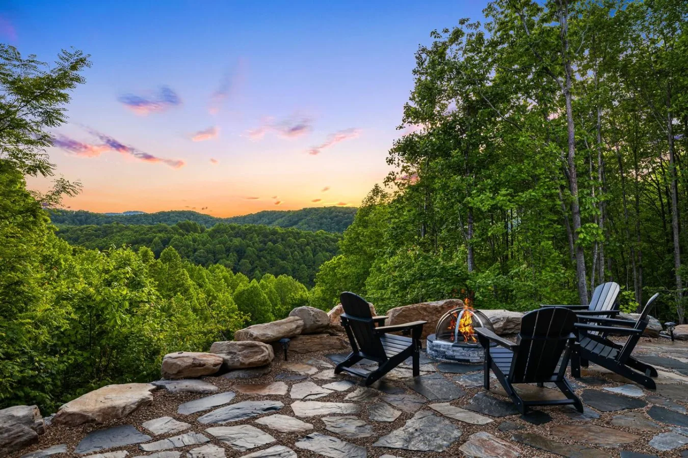 A Leisr Stays managed fire pit patio overlooking the mountains at sunset near Black Mountain, North Carolina