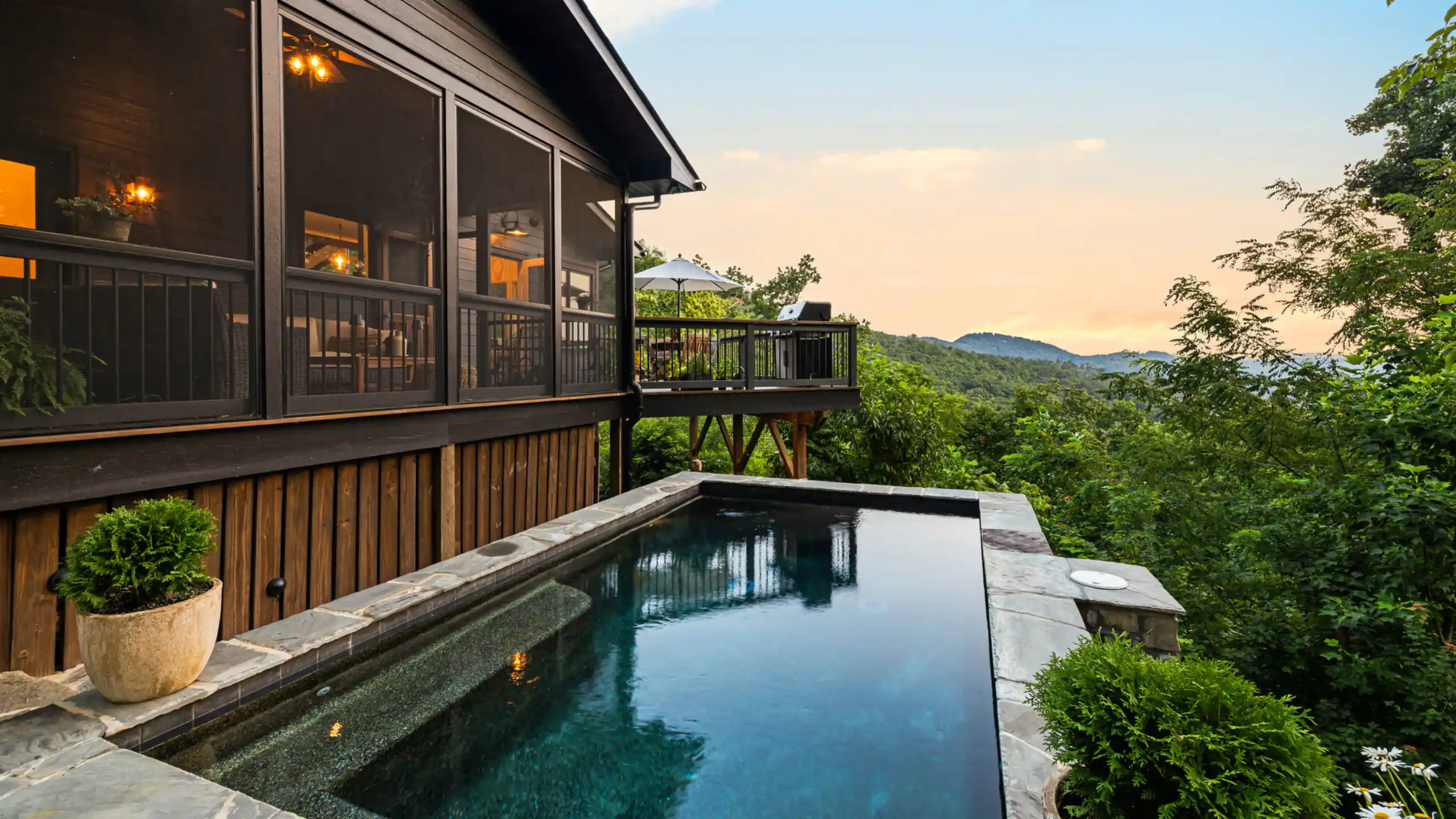 Golden hour at Ridgehaven, the infinity edge of the pool looking out over the Blue Ridge